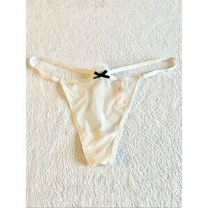 White sheer Victoria’s Secret thong new with tags with black bow detail and pom-